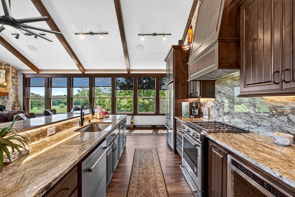 Kitchen with vaulted ceiling and large windows